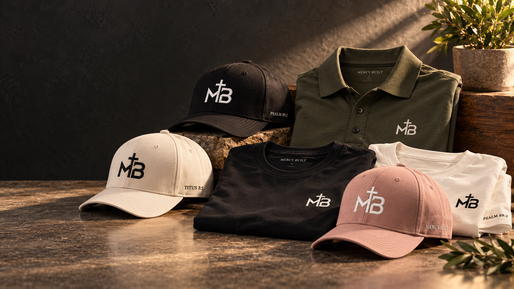 Mercy Built hats, tees, and polo in warm studio light